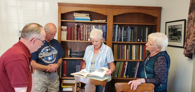 Individuals are searching for information in books at the Appleton Historical Society Research Room